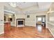 Open-concept living room features hardwood floors, a fireplace, and seamless flow to other rooms at 261 Melrose Sw Dr, Concord, NC 28025