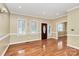 Bright living room with hardwood floors, large windows, and a warm, inviting atmosphere at 261 Melrose Sw Dr, Concord, NC 28025