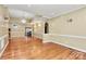 Spacious living room features hardwood floors, elegant chandelier, and detailed trim throughout at 261 Melrose Sw Dr, Concord, NC 28025