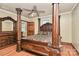 Primary bedroom featuring a decorative wooden bed frame, wood floors, ceiling fan, and neutral paint at 261 Melrose Sw Dr, Concord, NC 28025