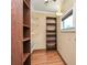 Walk-in closet with built-in shelving and hardwood floors maximizing organization and space at 261 Melrose Sw Dr, Concord, NC 28025