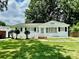 Charming white brick home with well-manicured lawn and symmetrical landscaping at 2823 Albany Ln, Charlotte, NC 28205