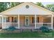 Charming home featuring a brick facade, covered porch, and lush landscaping at 28782 Canton Rd # A, Albemarle, NC 28001