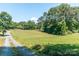 Expansive front lawn with a driveway, surrounded by mature trees at 28782 Canton Rd # A, Albemarle, NC 28001