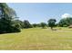 Open grass lawn in front of the house with trees in the background at 28782 Canton Rd # A, Albemarle, NC 28001