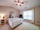 Cozy bedroom featuring a comfortable bed, a window, and bright neutral paint at 3055 Golden Dale Ln # 104, Charlotte, NC 28262