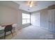Bedroom features a desk and a closet for extra storage at 3055 Golden Dale Ln # 104, Charlotte, NC 28262
