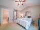 Bright bedroom featuring a ceiling fan, ensuite bathroom, and comfortable carpet at 3055 Golden Dale Ln # 104, Charlotte, NC 28262