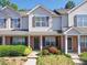 Traditional townhome featuring a brick facade, neutral siding and well-maintained landscaping at 3055 Golden Dale Ln # 104, Charlotte, NC 28262