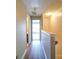 Hallway featuring wood floors leading to a bedroom and bathroom at 3055 Golden Dale Ln # 104, Charlotte, NC 28262