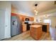 Well-lit kitchen featuring stainless steel refrigerator, black appliances and breakfast bar at 3055 Golden Dale Ln # 104, Charlotte, NC 28262