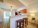 Open kitchen area with a breakfast bar, wood cabinets, and sliding glass doors to the backyard at 3055 Golden Dale Ln # 104, Charlotte, NC 28262
