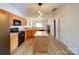 Spacious kitchen with an island, wood floors, and open layout to the living area at 3055 Golden Dale Ln # 104, Charlotte, NC 28262