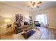 Cozy living room featuring wood floors, a ceiling fan, and ample natural light at 3055 Golden Dale Ln # 104, Charlotte, NC 28262