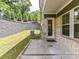 A covered patio area with a lush backyard view makes for quiet evenings at home at 3135 Everly Enclave Way, Charlotte, NC 28210
