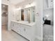 Bright bathroom with double vanity, quartz countertops, and large mirrors at 3135 Everly Enclave Way, Charlotte, NC 28210