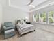 Inviting bedroom with a ceiling fan, large windows, and plush carpeting creating a cozy retreat at 3135 Everly Enclave Way, Charlotte, NC 28210