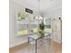 Cozy dining area features a glass table and view to the backyard at 3135 Everly Enclave Way, Charlotte, NC 28210