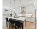 Modern kitchen with white cabinets, stainless steel appliances, and a large center island with seating at 3135 Everly Enclave Way, Charlotte, NC 28210