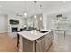 Open-concept kitchen with island seating, stainless steel appliances, and a seamless flow to the living area at 3135 Everly Enclave Way, Charlotte, NC 28210