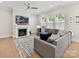Comfortable living room featuring a fireplace, large sectional sofa, and plenty of natural light at 3135 Everly Enclave Way, Charlotte, NC 28210