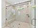 Modern tiled shower with glass enclosure, rainfall showerhead, and built-in bench seating at 3135 Everly Enclave Way, Charlotte, NC 28210