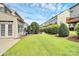 A peaceful backyard with lush lawn and mature hedges between homes at 3251 Park South Station Blvd, Charlotte, NC 28210