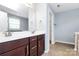 Bathroom featuring double vanity, tile flooring, and light blue walls at 3251 Park South Station Blvd, Charlotte, NC 28210