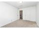Bedroom featuring neutral walls, carpet flooring, and a door leading to the hallway at 3251 Park South Station Blvd, Charlotte, NC 28210