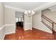 Open concept dining room with hardwood floors, staircase, and neutral paint at 3251 Park South Station Blvd, Charlotte, NC 28210