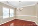 Formal dining room with hardwood floors, large windows and stylish chandelier at 3251 Park South Station Blvd, Charlotte, NC 28210