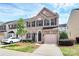 Charming brick townhome featuring a one-car garage and lush landscaping at 3251 Park South Station Blvd, Charlotte, NC 28210