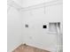 A well lit, practical laundry room with shelving, connections, and durable flooring at 3251 Park South Station Blvd, Charlotte, NC 28210
