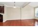 Sun-filled living room featuring hardwood floors, neutral walls, and contemporary lighting fixture at 3251 Park South Station Blvd, Charlotte, NC 28210