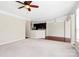 Open-concept living space with hardwood floors, ceiling fan, and view of the kitchen at 3251 Park South Station Blvd, Charlotte, NC 28210