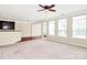 Bright and open living space featuring neutral walls, large windows, and a ceiling fan at 3251 Park South Station Blvd, Charlotte, NC 28210