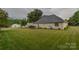 Wide shot of a vast backyard with green grass, shrubs, and a rear deck at 330 Kilmer Ln, Mooresville, NC 28115