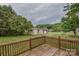 View of a spacious backyard with well-maintained grass and a wooden deck at 330 Kilmer Ln, Mooresville, NC 28115