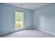 Cozy bedroom featuring a window offering plenty of natural light and neutral carpeting at 330 Kilmer Ln, Mooresville, NC 28115