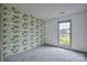 Bright bedroom with a window and a unique wallpaper that adds a touch of nature indoors at 330 Kilmer Ln, Mooresville, NC 28115