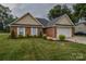 Well-maintained brick home with a two-car garage and lush green lawn at 330 Kilmer Ln, Mooresville, NC 28115