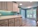 Bright kitchen with a window and white cabinets and countertop, and wood-look flooring at 330 Kilmer Ln, Mooresville, NC 28115