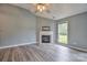 Spacious living room with a fireplace, large window, and stylish flooring at 330 Kilmer Ln, Mooresville, NC 28115