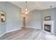 Open-concept living room with fireplace and updated flooring at 330 Kilmer Ln, Mooresville, NC 28115
