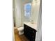 Modern bathroom with a storage cabinet, an updated sink, and a shower with glass doors at 3701 Tipperary Pl, Charlotte, NC 28215