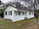 Charming white-brick ranch home featuring black shutters, covered porch, and a well-maintained front yard at 3701 Tipperary Pl, Charlotte, NC 28215