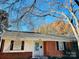 Charming single-story home with brick accents and a well-maintained front yard under a blue sky at 3701 Tipperary Pl, Charlotte, NC 28215
