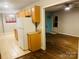 Open kitchen design featuring wood cabinets, neutral countertops, and hardwood floors extending to living area at 3701 Tipperary Pl, Charlotte, NC 28215
