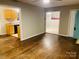 Spacious living room with hardwood floors, seamless flow into the kitchen and other rooms at 3701 Tipperary Pl, Charlotte, NC 28215