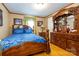 Bedroom showcases a detailed wood bed frame, matching dresser, and natural light from the window at 404 St Lukes Church Rd, Kings Mountain, NC 28086